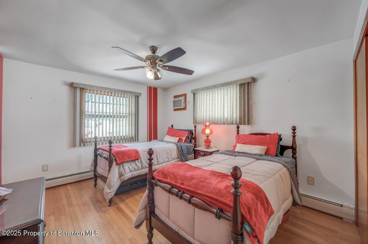 216 Prospect Street Dunmore, PA 18512 - Photo 22 of 81 a bedroom with two beds and a chandelier