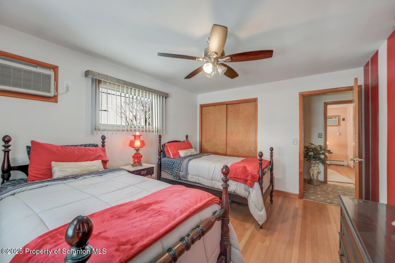 216 Prospect Street Dunmore, PA 18512 - Photo 24 of 81 a bedroom with two beds and a chandelier