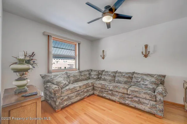 a bedroom with a large bed and a chandelier fan