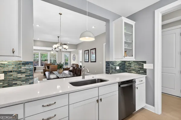 a kitchen with counter space cabinets appliances and furniture