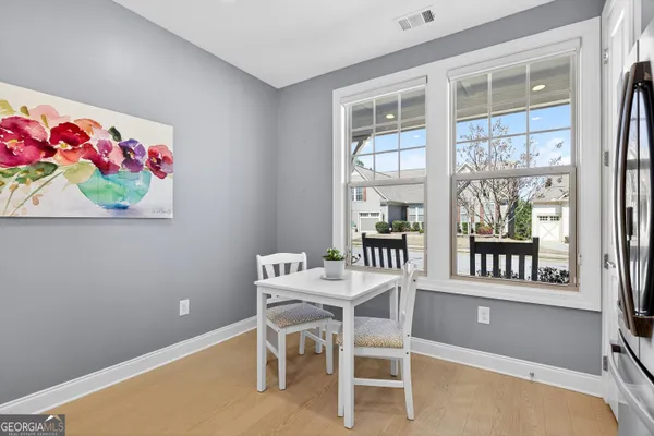a view of a dining room with furniture and a chandelier