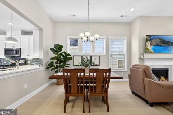 a living room with furniture a fireplace and a floor to ceiling window