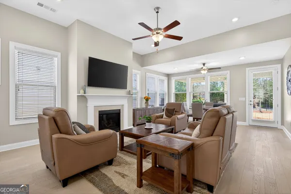a living room with furniture a fireplace and a chandelier