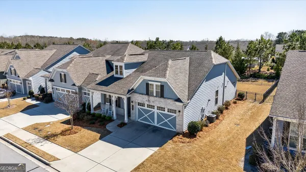 an aerial view of a house with a big yard