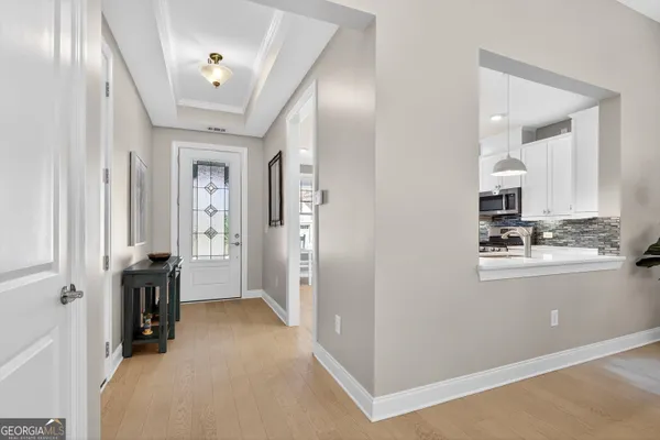 a kitchen with white cabinets and white appliances