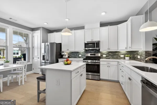 a kitchen with a white cabinets and stove top oven
