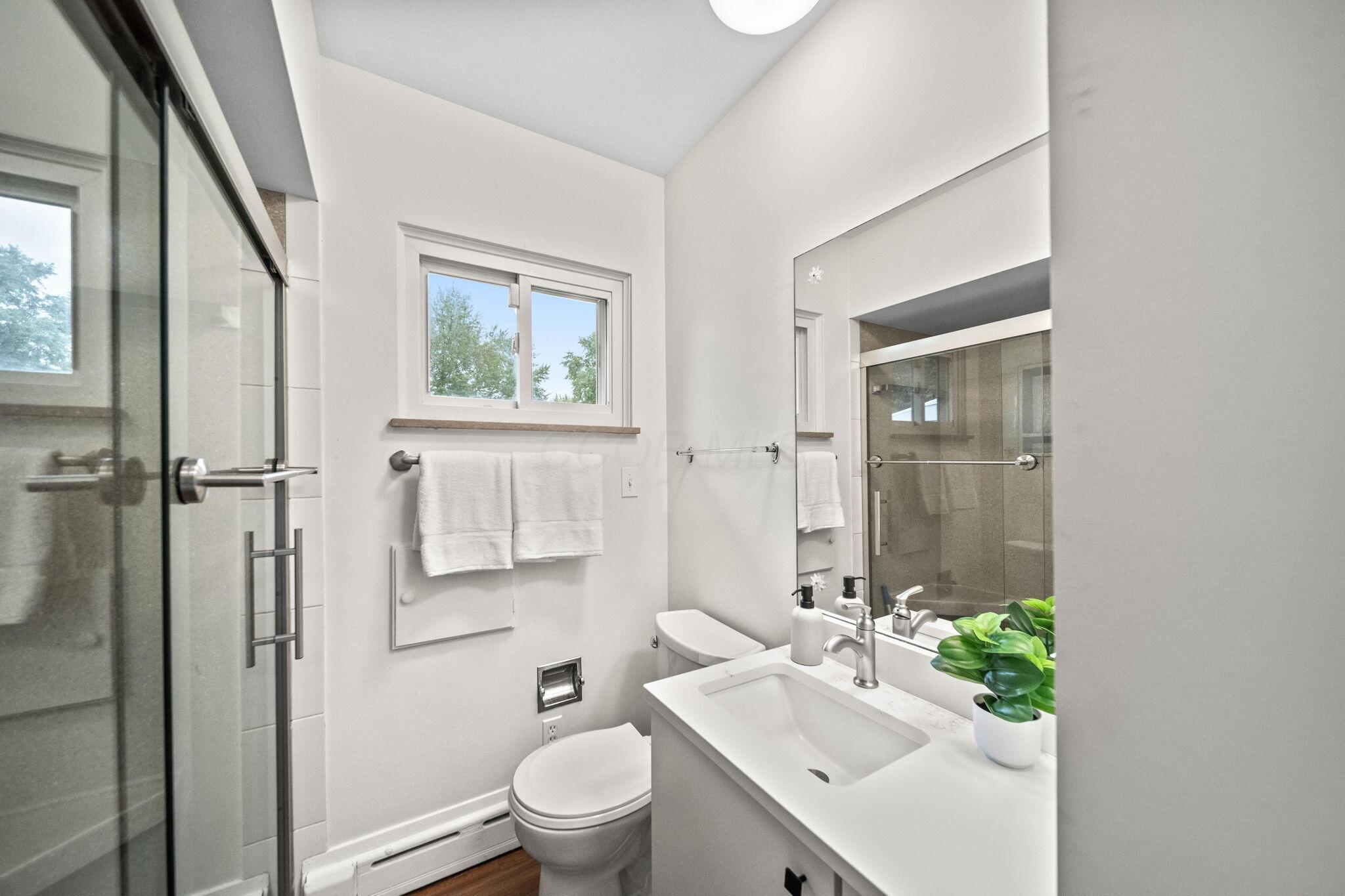 3496 Wicklow Road Columbus, OH 43204 - Photo 23 of 53 White vanity with integrated sink, chrome faucet, and rectangular mirror