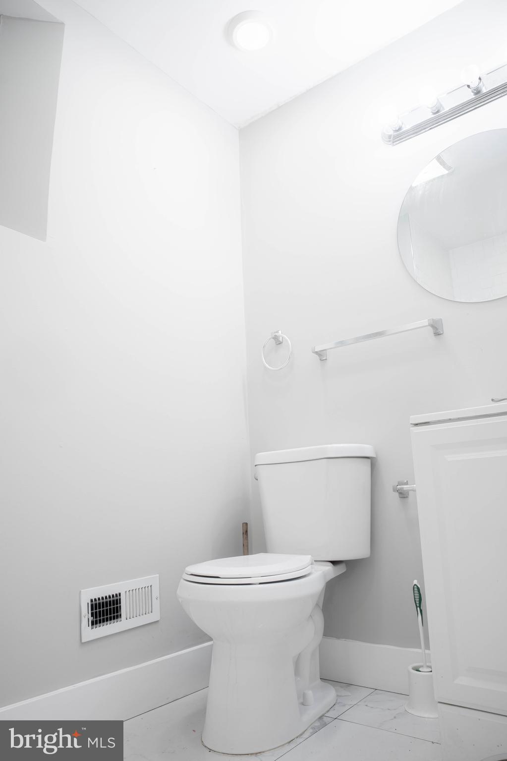 2348 Moore Street Philadelphia, PA 19145 - Photo 11 of 27 a white toilet sitting next to a white sink and vanity