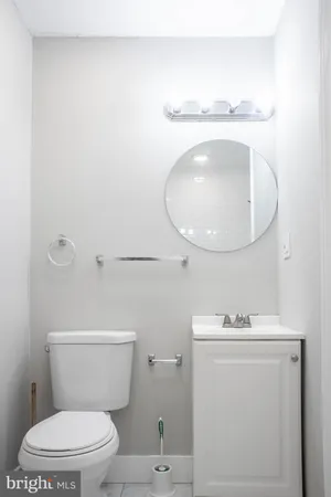 an entryway with wooden floor and cabinet