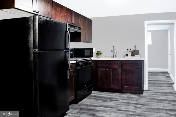 a kitchen with a refrigerator stove and cabinets