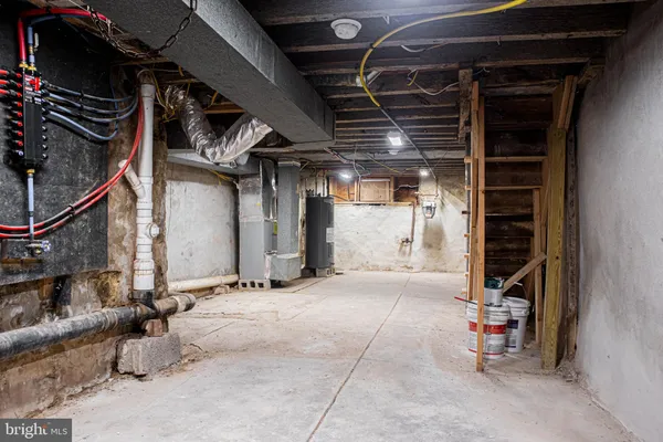 an empty room with windows and chandelier