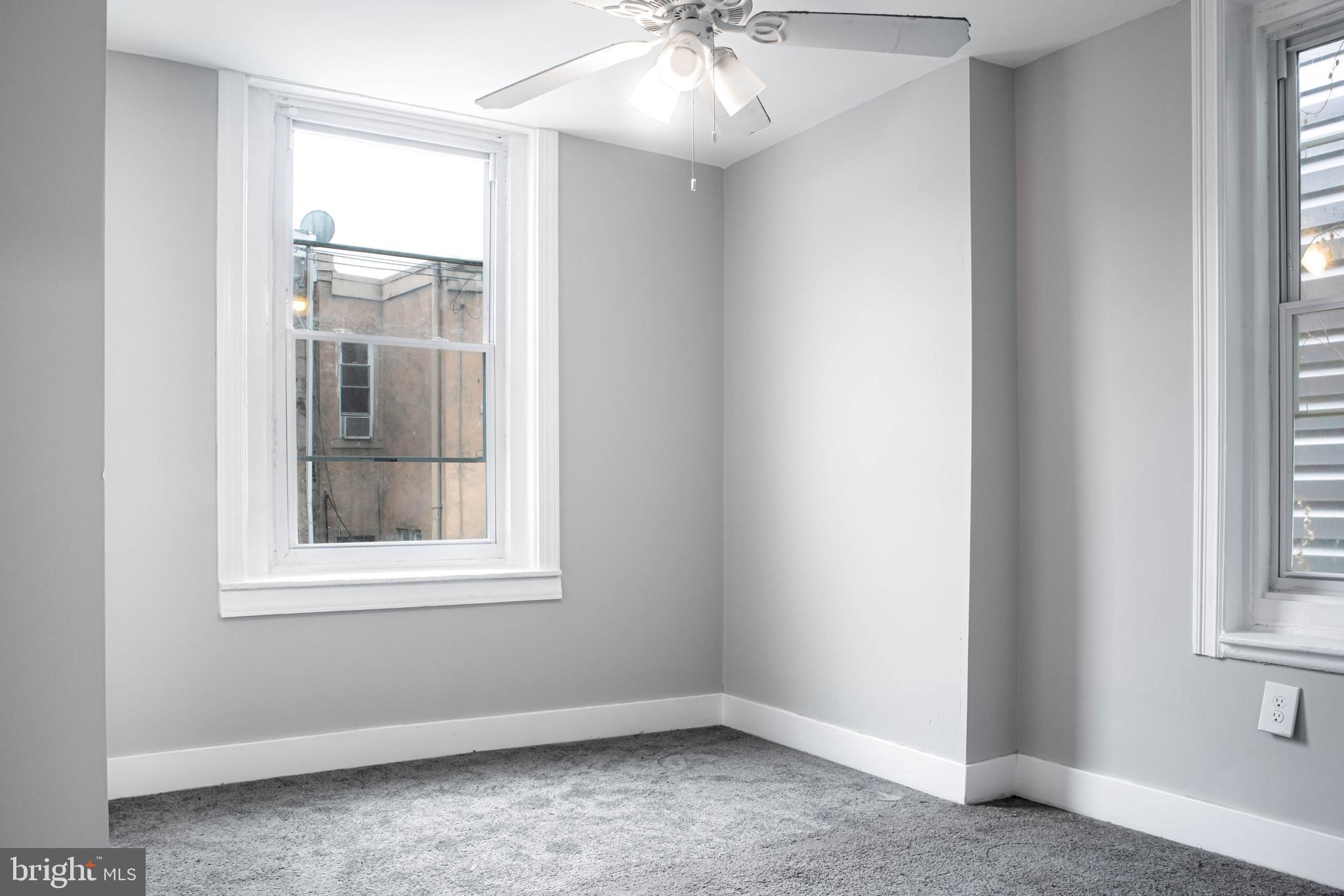 2348 Moore Street Philadelphia, PA 19145 - Photo 22 of 27 an empty room with windows and chandelier