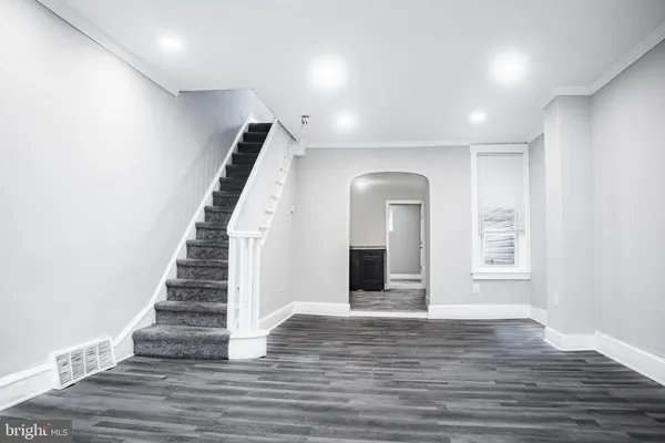 a view of an entryway with wooden floor