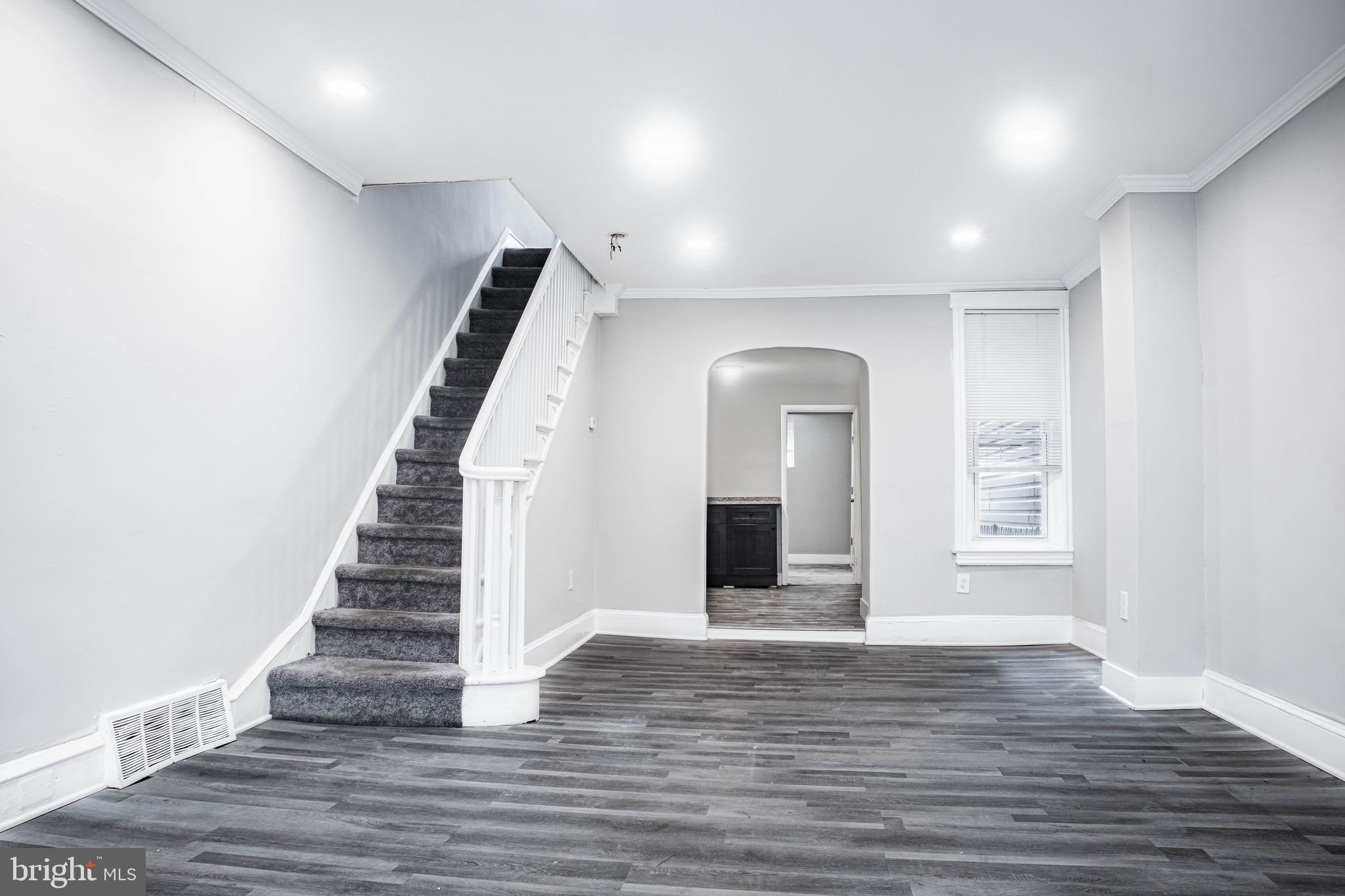 2348 Moore Street Philadelphia, PA 19145 - Photo 26 of 27 a view of an empty room with wooden floor and stairs