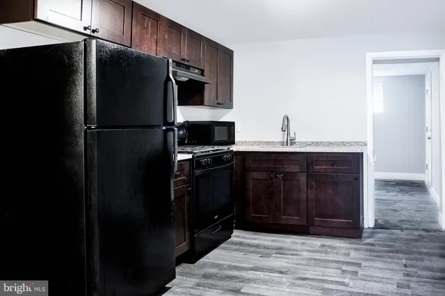 a kitchen with a refrigerator stove and cabinets