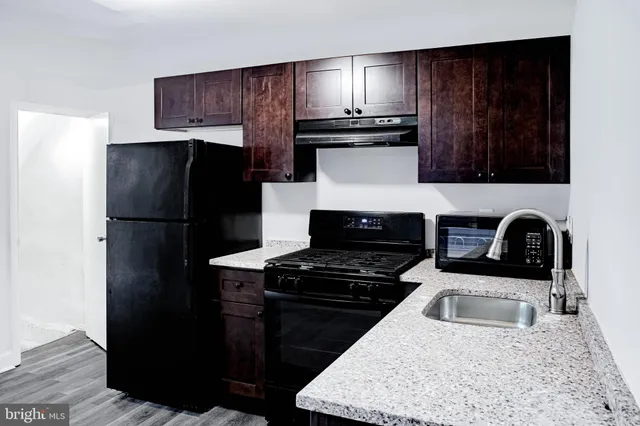 a kitchen with a refrigerator and a sink