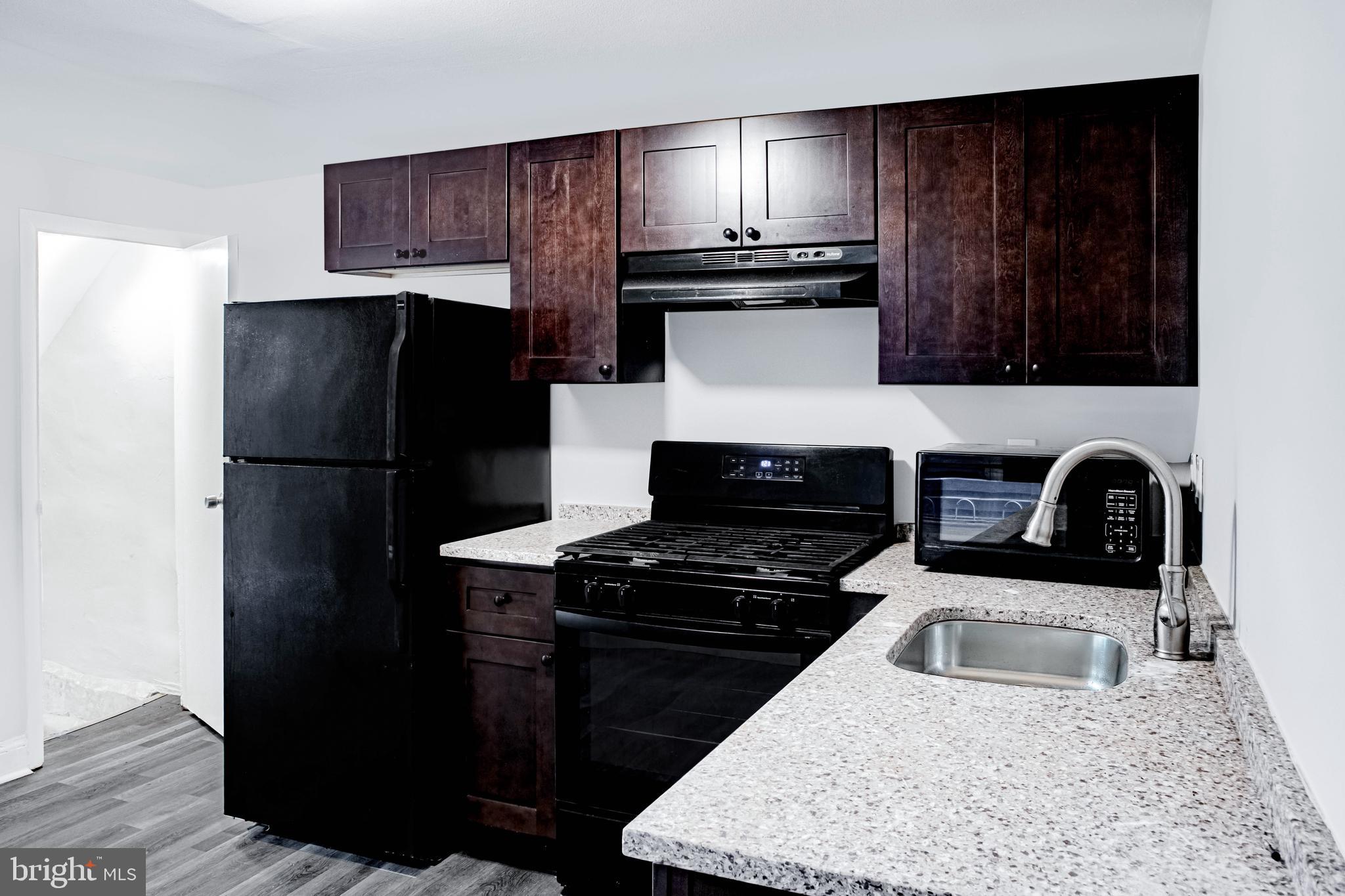 2348 Moore Street Philadelphia, PA 19145 - Photo 4 of 27 a kitchen with a refrigerator and a sink