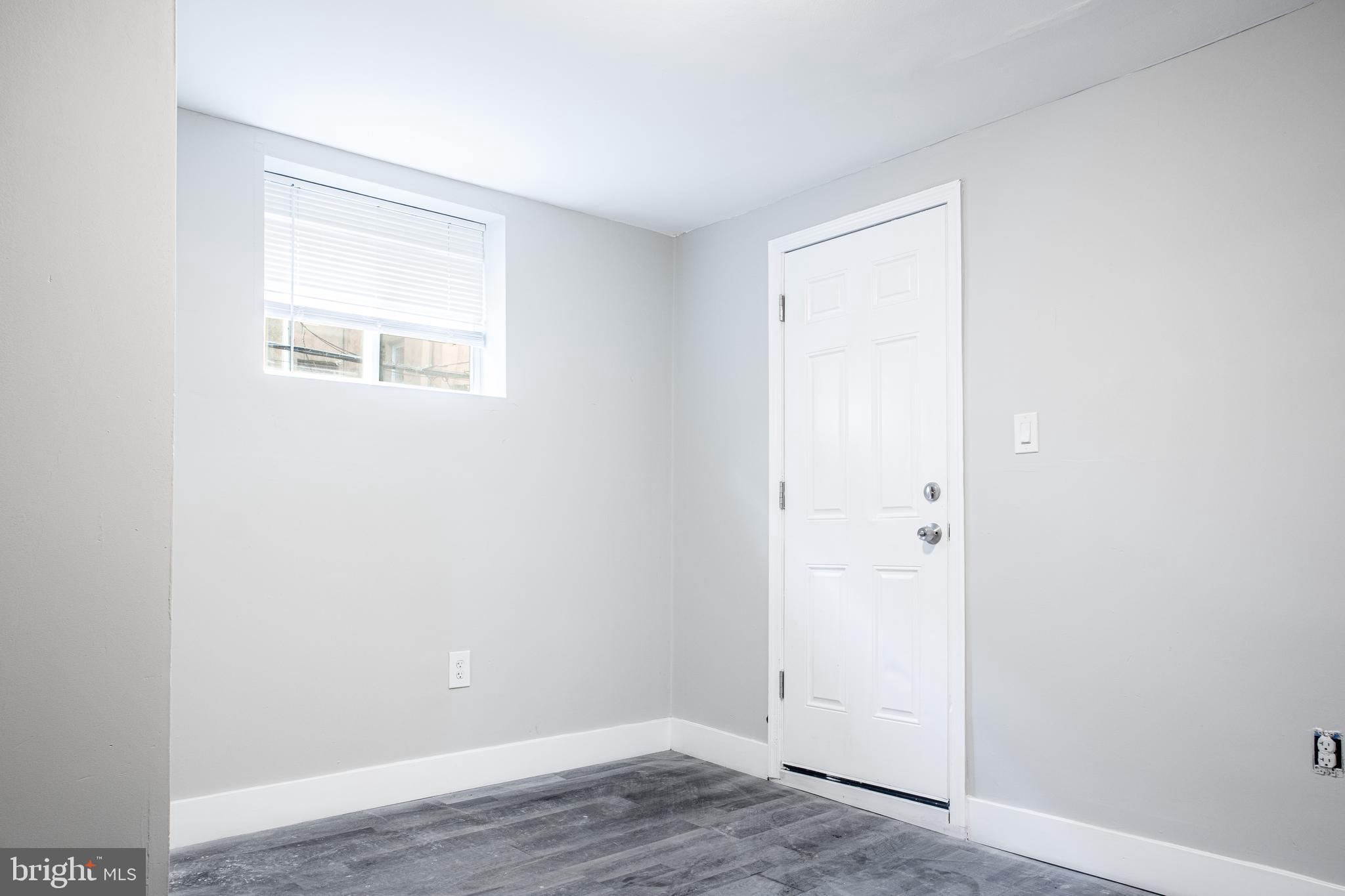 2348 Moore Street Philadelphia, PA 19145 - Photo 5 of 27 an empty room with wooden floor and a window