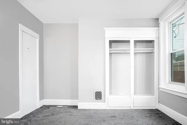 a white toilet sitting next to a white sink and vanity