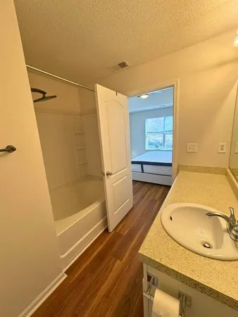 a bathroom with a sink a mirror and a shower