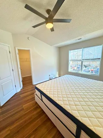 a bed sitting in a bedroom next to a window