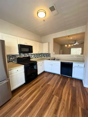 a kitchen with stainless steel appliances granite countertop a stove and a sink