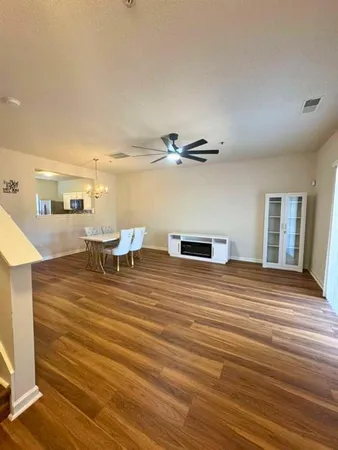 a room with wooden floor and furniture