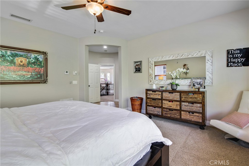 1609 Vista Luna San Clemente, CA 92673 - Photo 12 of 33 a bedroom with a bed and a chandelier