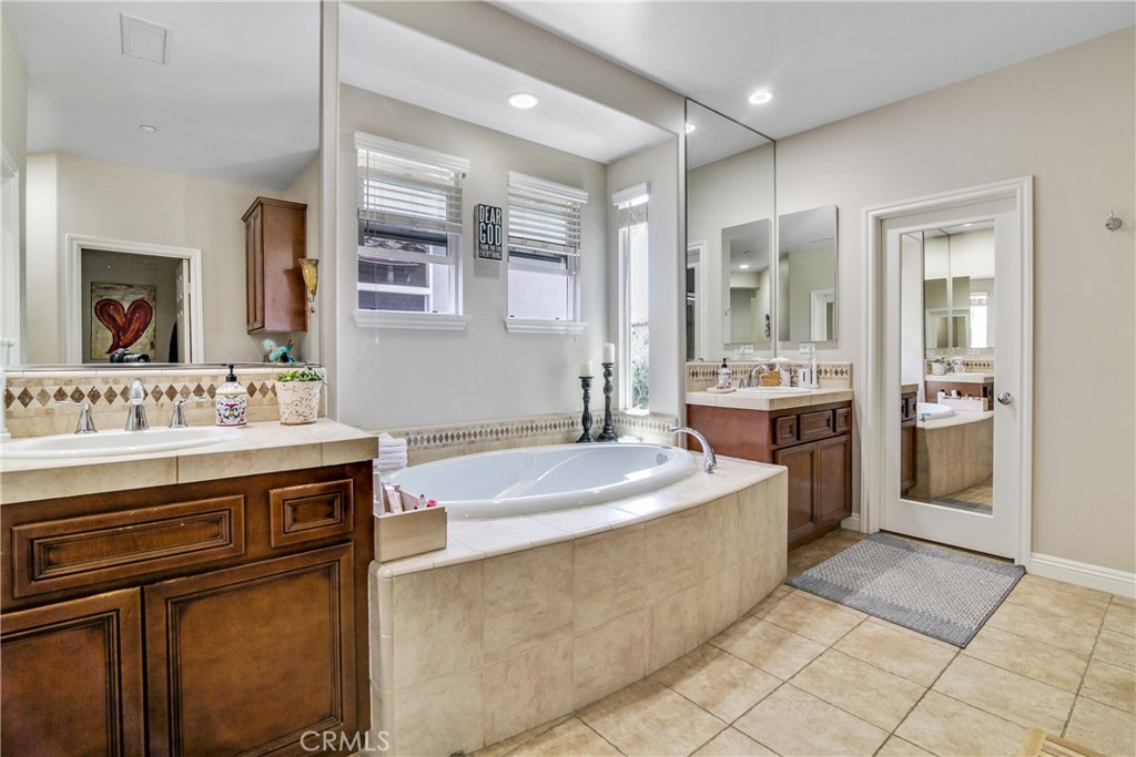 1609 Vista Luna San Clemente, CA 92673 - Photo 13 of 33 a spacious bathroom with a sink double vanity and a mirror