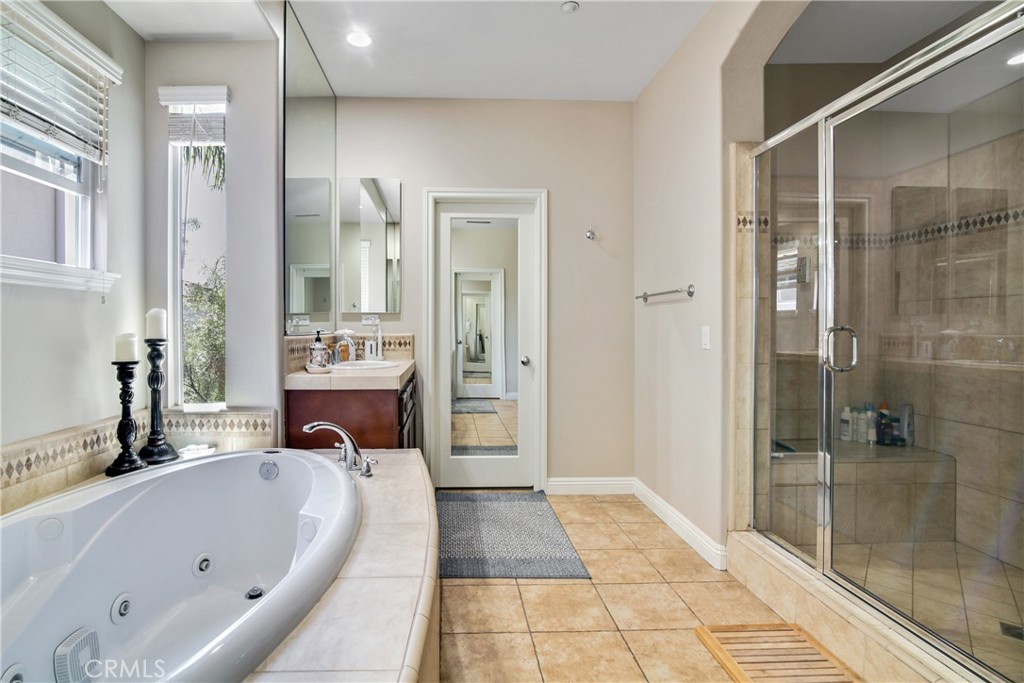 1609 Vista Luna San Clemente, CA 92673 - Photo 14 of 33 a spacious bathroom with a tub shower and mirror