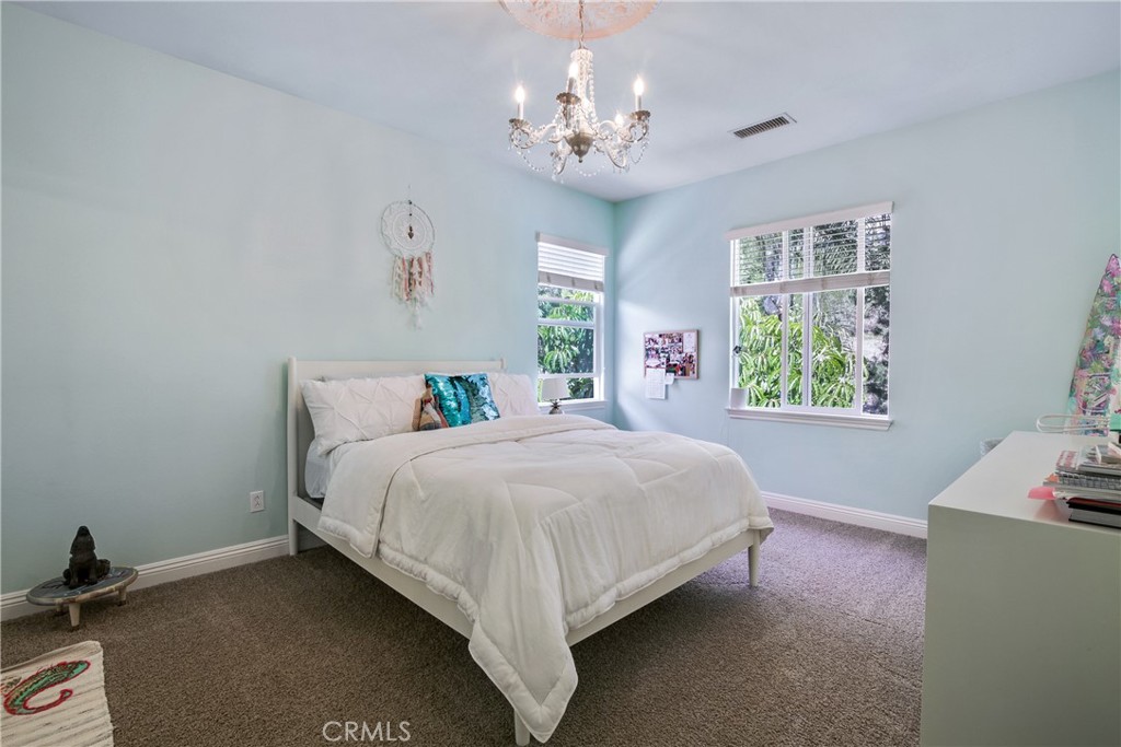 1609 Vista Luna San Clemente, CA 92673 - Photo 16 of 33 a bedroom with a bed and a window