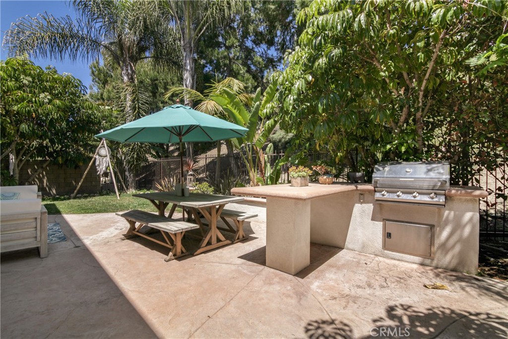 1609 Vista Luna San Clemente, CA 92673 - Photo 18 of 33 a view of a patio with couches table and chairs under an umbrella with a barbeque