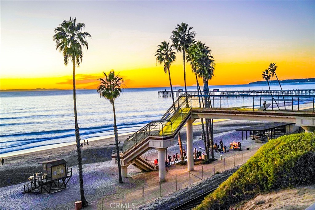 1609 Vista Luna San Clemente, CA 92673 - Photo 32 of 33 a view of a swimming pool with a chair and palm trees