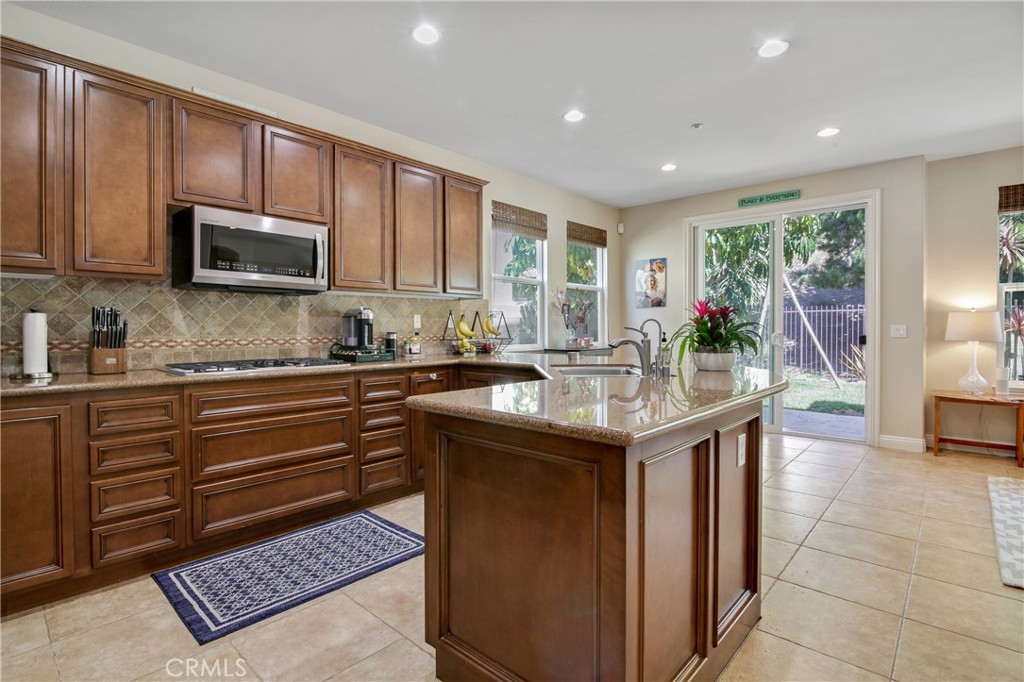 1609 Vista Luna San Clemente, CA 92673 - Photo 5 of 33 a kitchen with granite countertop a sink stove and cabinets