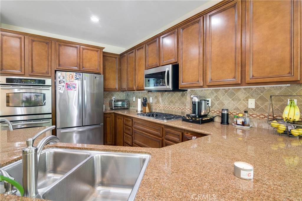 1609 Vista Luna San Clemente, CA 92673 - Photo 6 of 33 a kitchen with stainless steel appliances granite countertop a refrigerator a stove top oven a sink and dishwasher