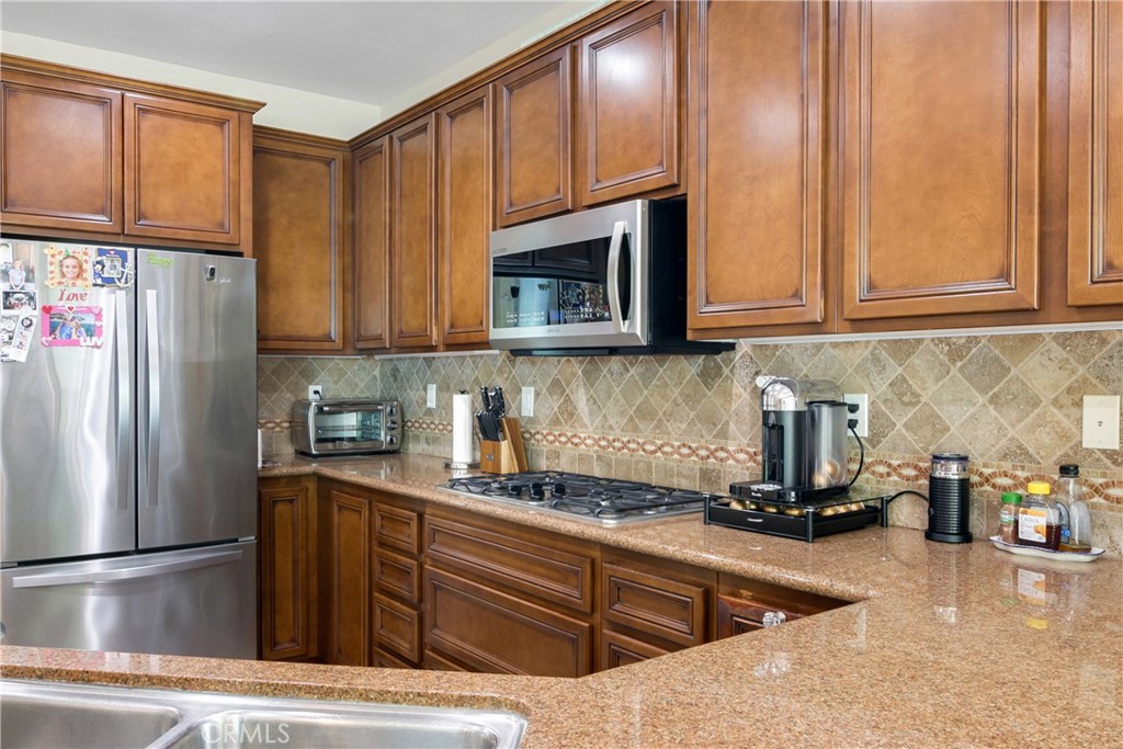 1609 Vista Luna San Clemente, CA 92673 - Photo 7 of 33 a kitchen with stainless steel appliances granite countertop a refrigerator stove and sink