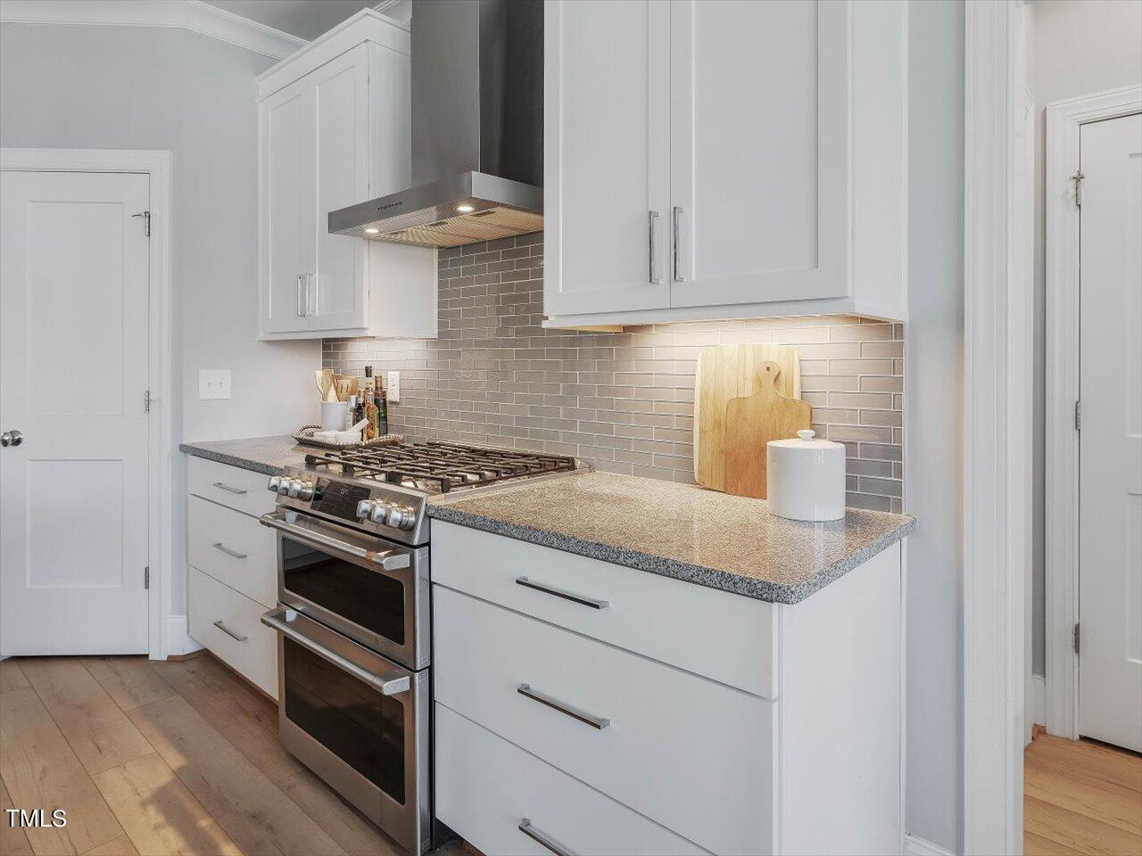 9117 Penny Road Raleigh, NC 27606 - Photo 12 of 72 a kitchen with granite countertop white cabinets and stainless steel appliances