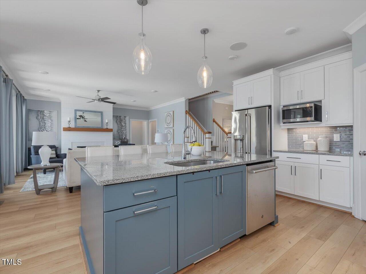 9117 Penny Road Raleigh, NC 27606 - Photo 13 of 72 a kitchen with counter top space cabinets and stainless steel appliances