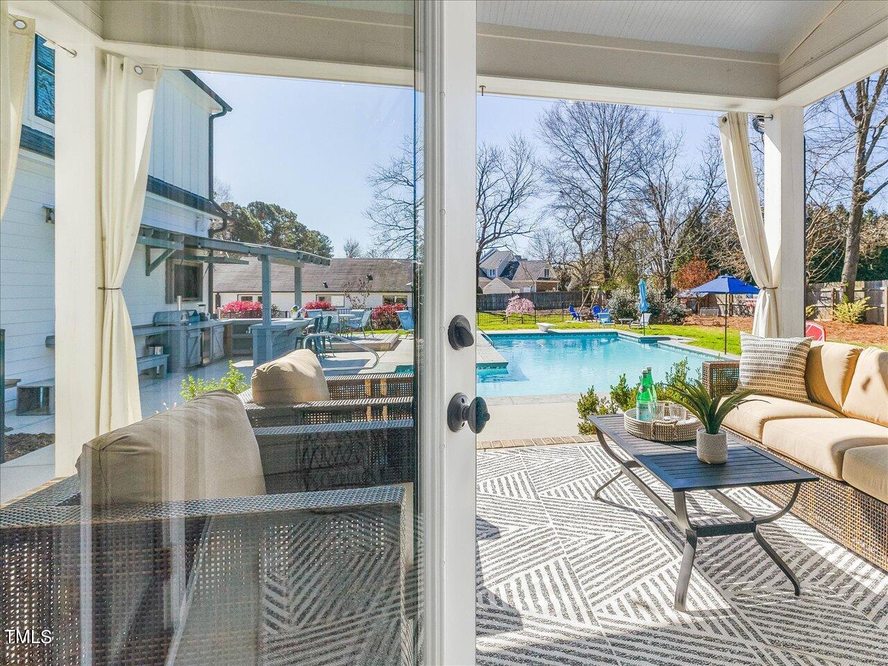 9117 Penny Road Raleigh, NC 27606 - Photo 16 of 72 a balcony with furniture and a floor to ceiling window