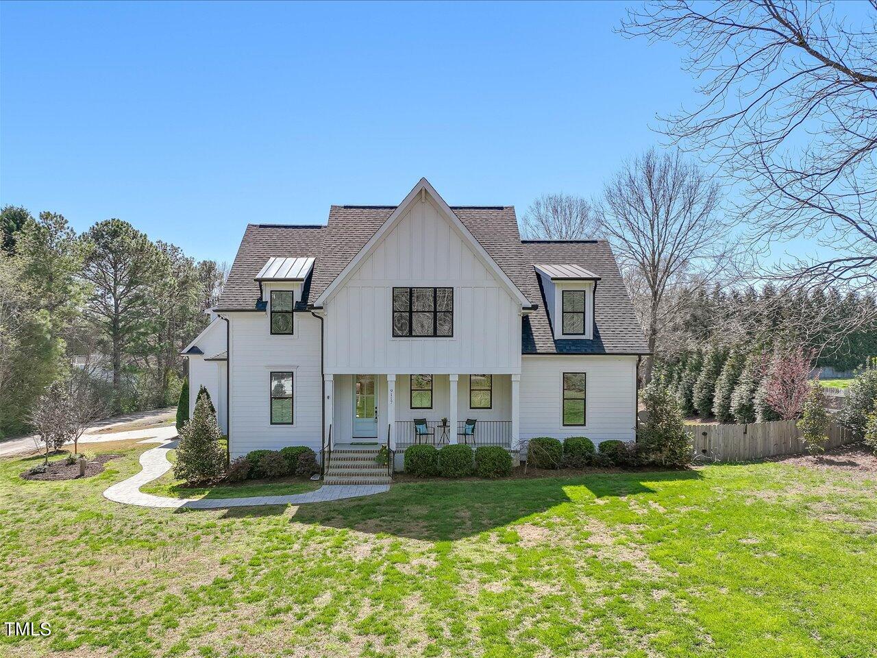 9117 Penny Road Raleigh, NC 27606 - Photo 2 of 72 a front view of a house with a yard