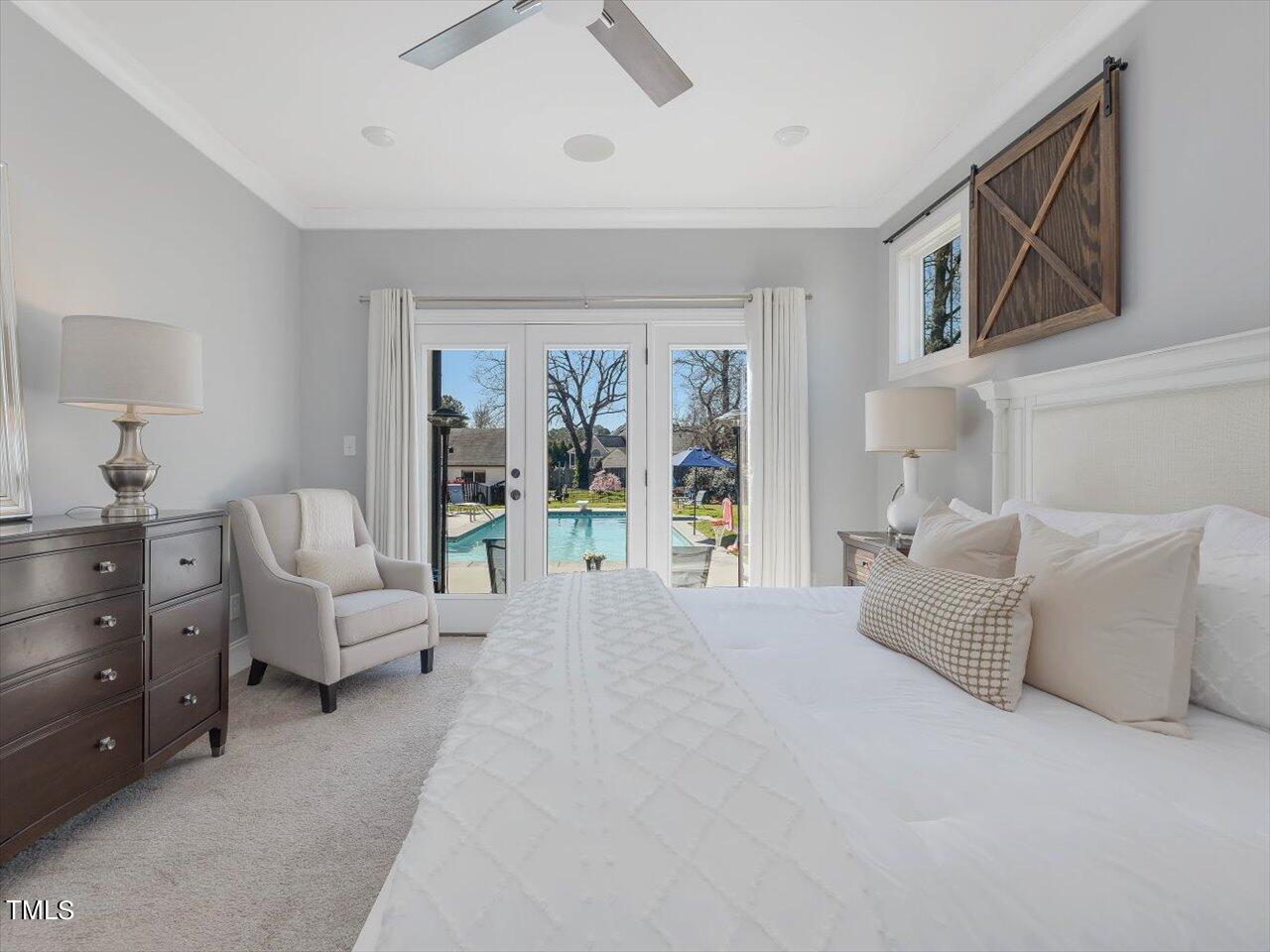9117 Penny Road Raleigh, NC 27606 - Photo 21 of 72 a spacious bedroom with a large bed couch and a window
