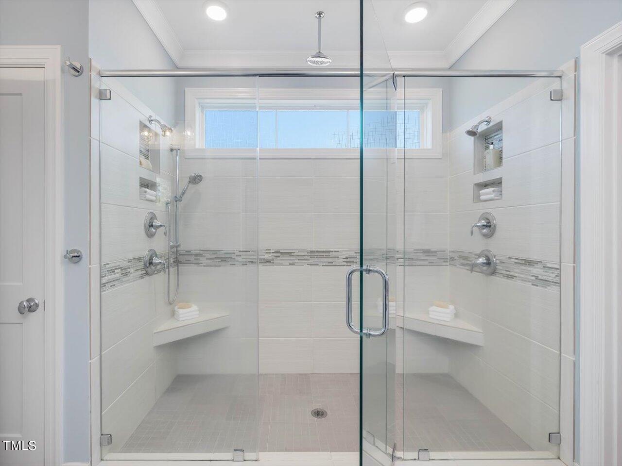 9117 Penny Road Raleigh, NC 27606 - Photo 23 of 72 a bathroom with a shower and a glass door