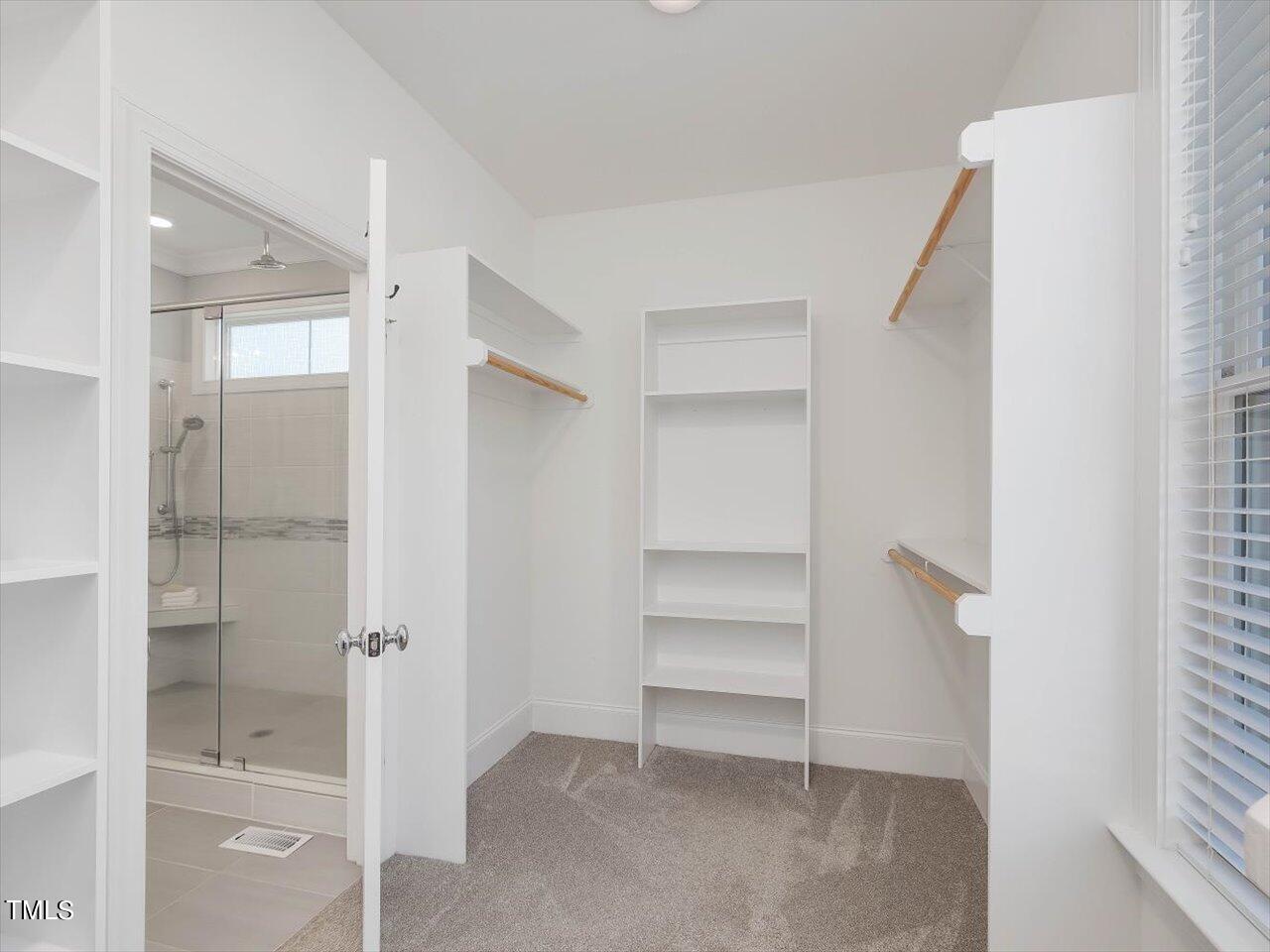 9117 Penny Road Raleigh, NC 27606 - Photo 24 of 72 a view of closet area with empty racks