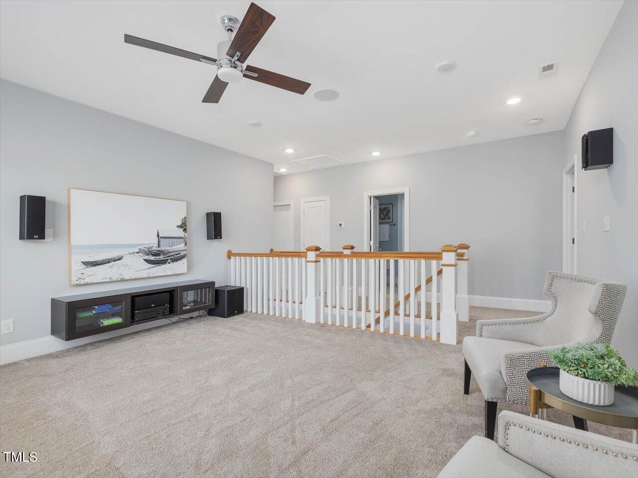 9117 Penny Road Raleigh, NC 27606 - Photo 32 of 72 a living room with furniture ceiling fan and a wooden floor