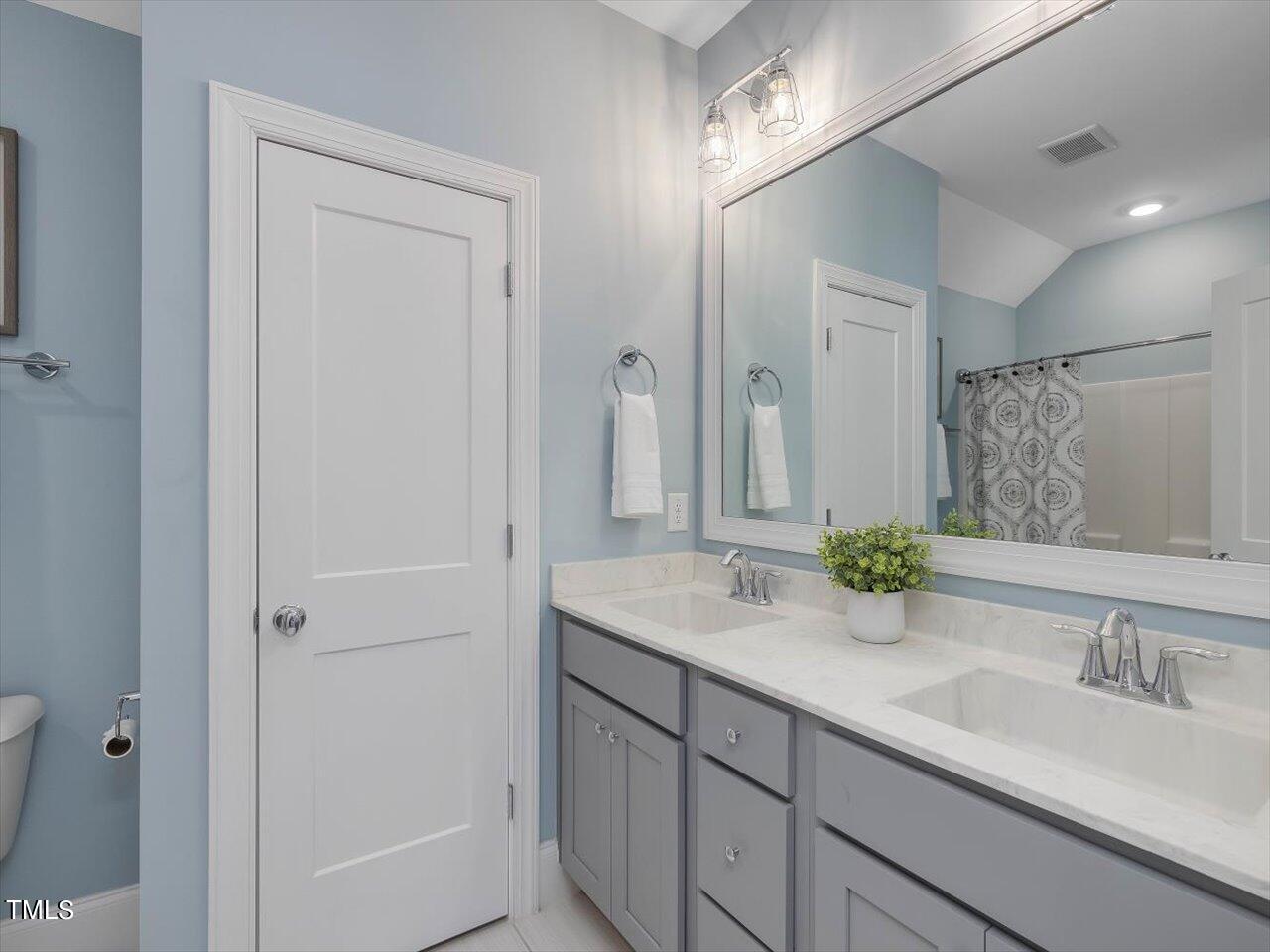 9117 Penny Road Raleigh, NC 27606 - Photo 35 of 72 a bathroom with a sink and a mirror