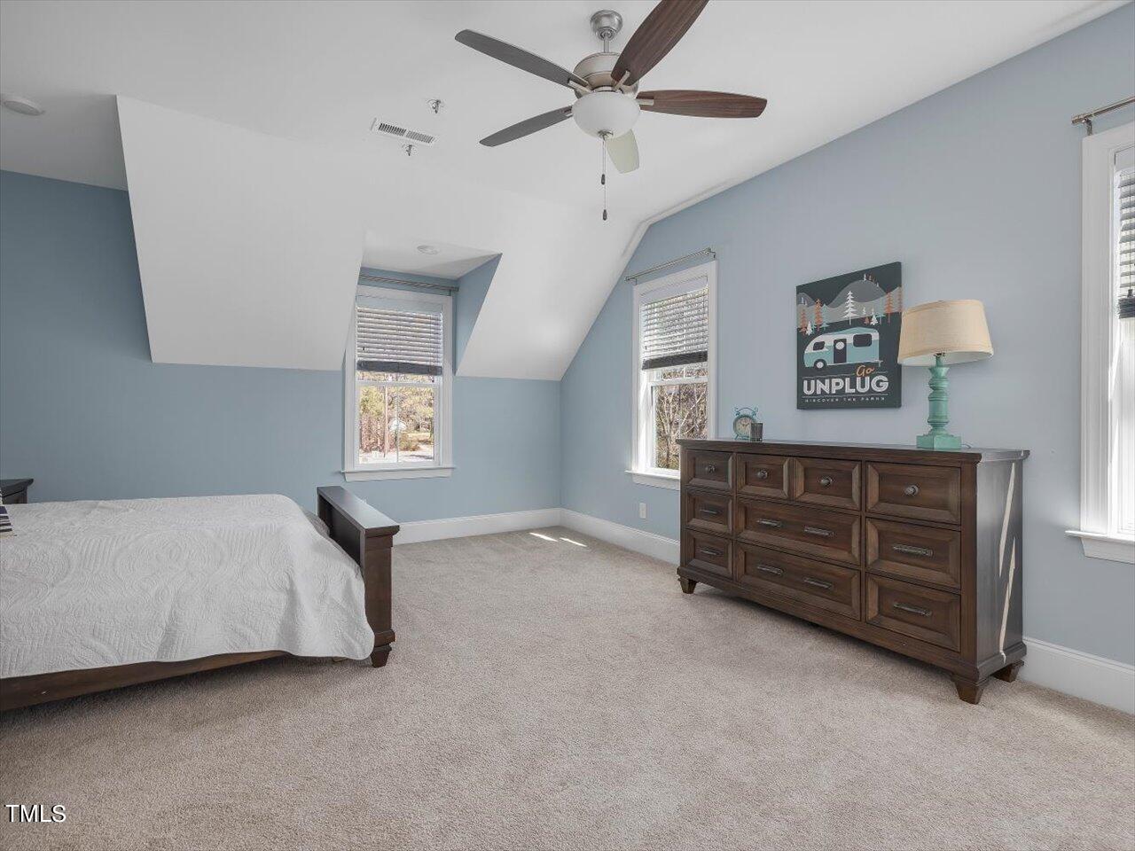 9117 Penny Road Raleigh, NC 27606 - Photo 37 of 72 a bed room with a bed and a ceiling fan