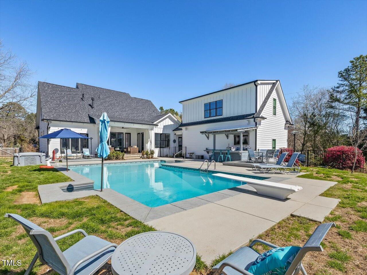 9117 Penny Road Raleigh, NC 27606 - Photo 44 of 72 a front view of a house with swimming pool having outdoor seating