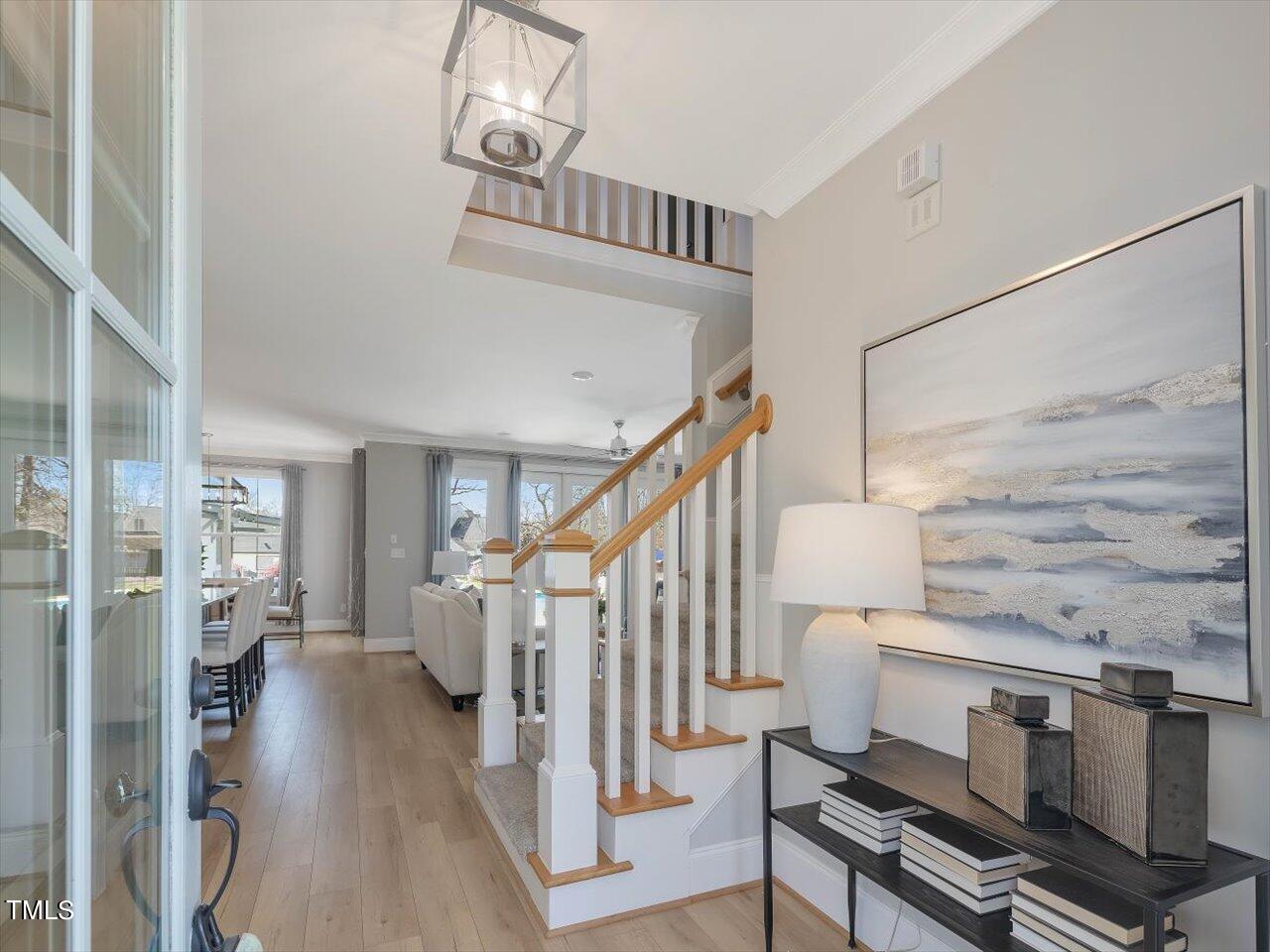 9117 Penny Road Raleigh, NC 27606 - Photo 5 of 72 a view of entryway and hall with wooden floor