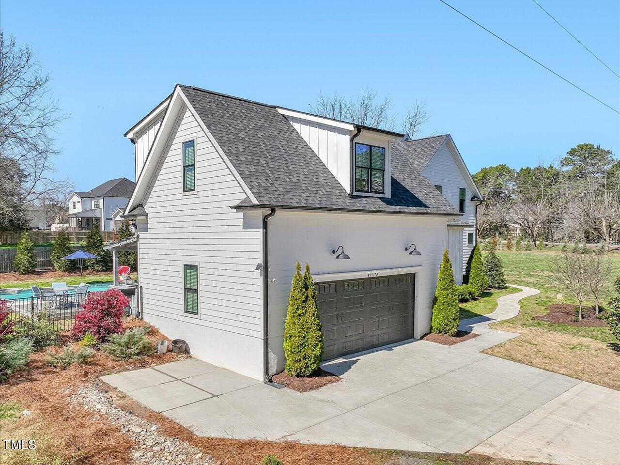 9117 Penny Road Raleigh, NC 27606 - Photo 52 of 72 a view of a house with a yard and potted plants