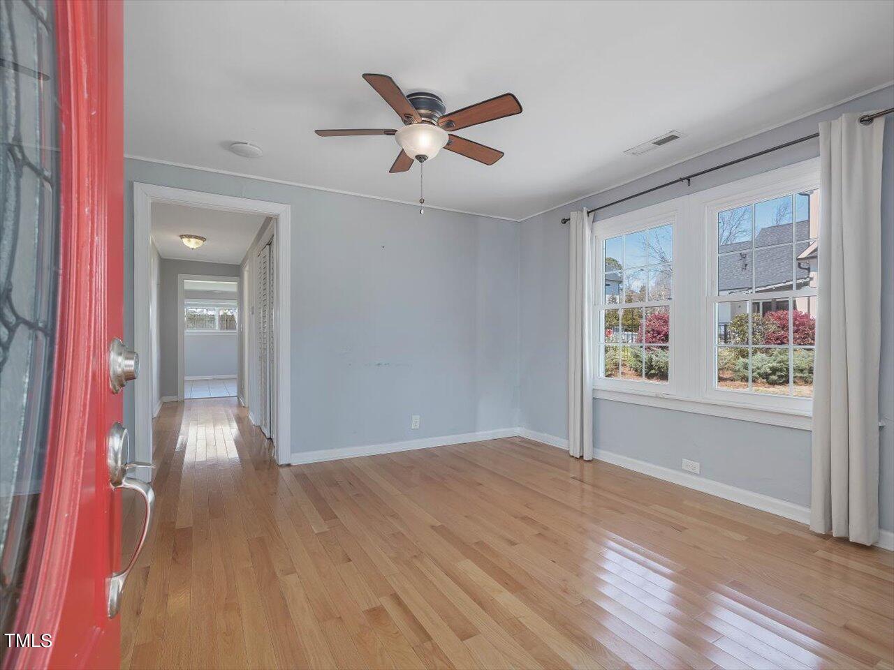 9117 Penny Road Raleigh, NC 27606 - Photo 55 of 72 a view of a livingroom with a ceiling fan and wooden floor